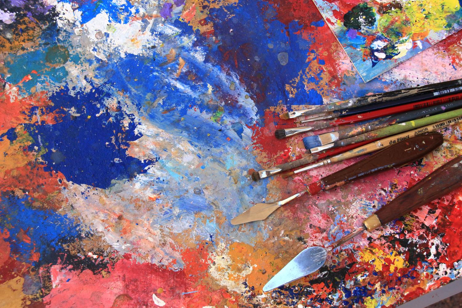 Staffelei mit bunten Farben, Pinseln und Spateln